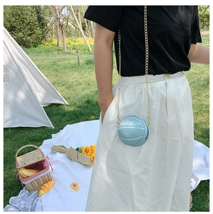 Close-up of a light blue basketball-shaped mini bag with a gold chain strap for kids