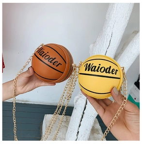 Detail of creative basketball-shaped mini chain bags in brown and yellow synthetic leather
