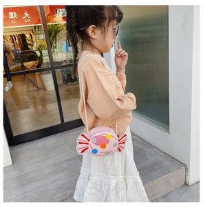 Pink round candy-shaped crossbody bag for children with colorful polka dots and stripes