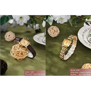 Vintage rectangular gold watch with steel and leather straps on green velvet background
