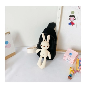 Close-up of black canvas kids chest bag with a cute plush bunny and adjustable strap
