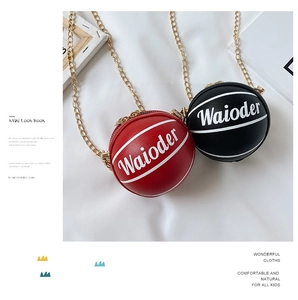 Detailed macro view of basketball-shaped mini crossbody bags with gold chains