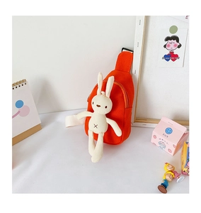 Detail of orange canvas kids chest bag with a cute white plush bunny charm attachment