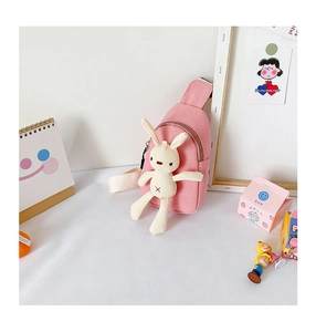Detailed close-up of pink canvas kids chest bag with a cute 3D bunny plush toy attachment
