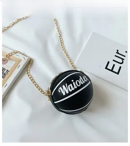 Detail of creative black basketball shaped bag with gold chain and Waioder text