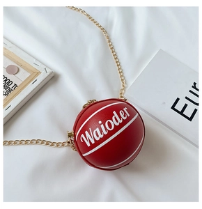 Detail of reddish brown basketball bag with white text, leather texture and gold chain strap