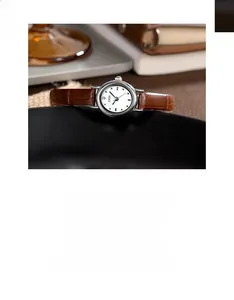 Close-up of GEDI vintage women's watch with brown leather strap and elegant white dial