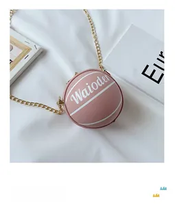 Detailed view of creative pink basketball-shaped cross-body bag with gold chain strap