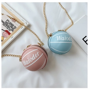 Detailed view of basketball shaped crossbody bags in pink and blue with chain straps