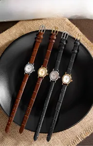 Macro shot of four elegant oval quartz watches with crocodile pattern leather straps