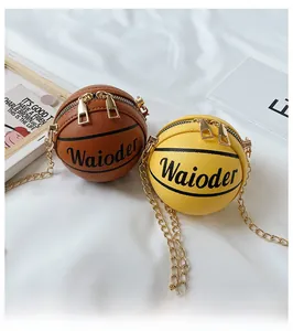 Detail of basketball-shaped mini crossbody bags with lychee leather and gold chains
