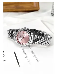 Dettaglio del quadrante rosa con finestra data e lunetta zigrinata su orologio