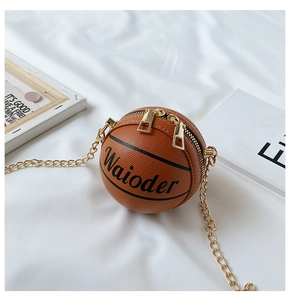Close-up of basketball-shaped crossbody bag with gold zippers and textured PU finish