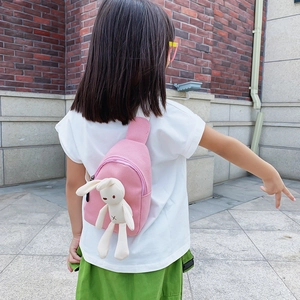 Pink canvas crossbody bag for kids featuring a cute plush bunny and adjustable strap
