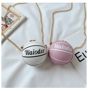 Detail of pink and white basketball-shaped mini bags with gold chain straps and texture
