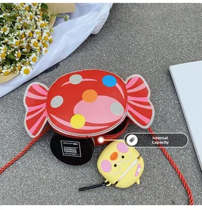 Detail view of red candy-shaped kid's crossbody bag showing internal storage capacity