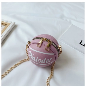 Close-up of pink basketball-shaped shoulder bag with textured PU leather and gold chain