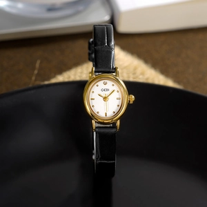 Elegant oval women's quartz watch with gold metal bezel and black leather strap