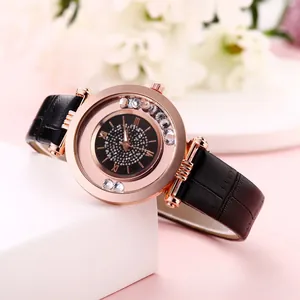 Detail of rose gold watch with floating crystals and black leather strap