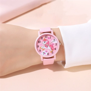 Close-up of pink girls watch with cartoon unicorn dial and clear Arabic numerals