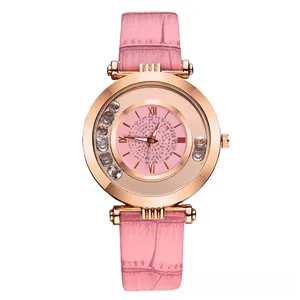 Detail of rose gold quartz watch featuring a pink leather strap and crystal-filled dial