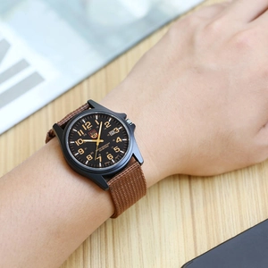 Men's military sport quartz watch with brown nylon strap and black dial on wrist
