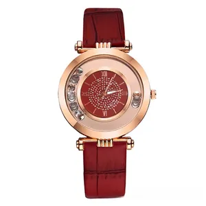 Detail view of women watch with red crocodile pattern strap and rhinestone dial