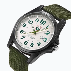 Detail of army green nylon strap and military dial with date display and luminous hands