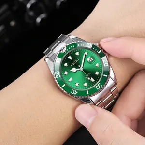 Macro shot of silver stainless steel men's watch with green dial and date window