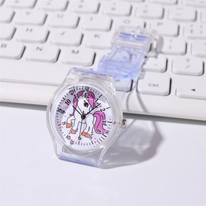 Kids quartz watch with pink unicorn dial and transparent plastic strap on desk