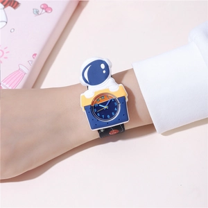 Close-up of a blue kids space watch with 3D astronaut decor on a wrist background