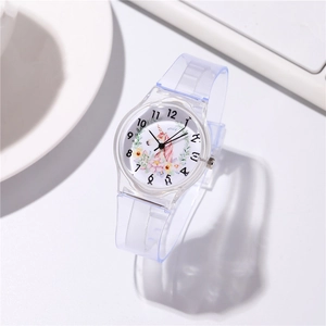 Macro shot of children's quartz watch with unicorn motif and clear plastic strap