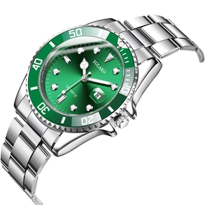 Detail view of silver stainless steel watch with green dial and date display window