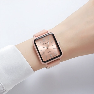 Close-up of a pink silicone sports watch with a rectangular rose gold striped dial on wrist