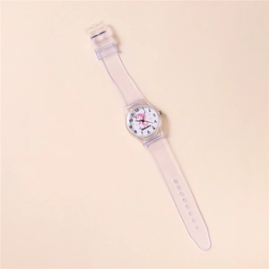 Detail of quartz student watch with a pink unicorn dial and transparent plastic strap