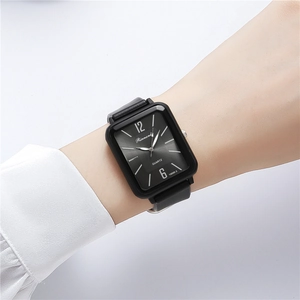 Fashionable women quartz watch with black rectangular dial and silicone strap on wrist