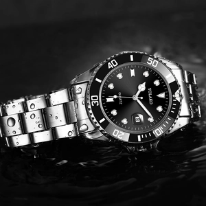 Close-up of waterproof quartz watch with silver steel band on water-splashed surface
