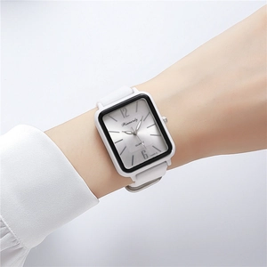 Close-up of stylish rectangular quartz watch with white silicone strap on wrist