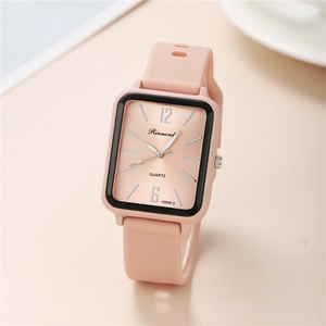 Detail of pink rectangular quartz watch with silicone strap and brushed metal dial