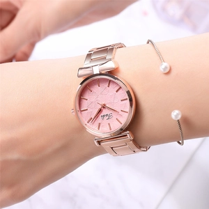 Close-up of rose gold mesh watch with embossed leaf pattern on pink dial and thin bracelets