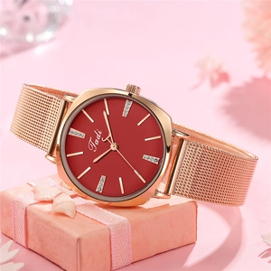 Women's rose gold mesh strap watch with red dial and rhinestone indices on gift box