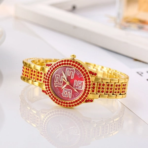 Luxury gold women's watch with red crystal bezel and sparkling diamond numeral dial