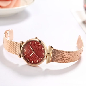 Women's rose gold mesh band quartz watch with deep red sunburst dial and gold numerals