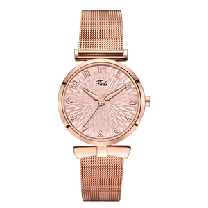 Detail of rose gold mesh strap watch featuring geometric dial and Arabic numerals