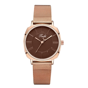 Close-up of rose gold mesh band and brown dial on a minimalist fashion quartz watch