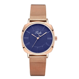 Close-up of rose gold mesh strap and deep blue dial on women's quartz watch