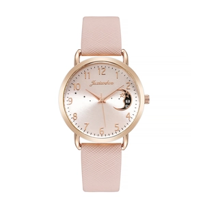 Detailed view of women's watch featuring a moon and star dial with a pink leather strap