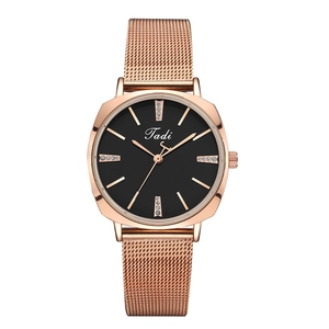 Detail view of Tadi rose gold watch with black dial and crystal markers on mesh strap