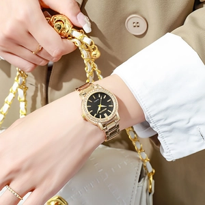 Montre à quartz de luxe pour femme en acier doré avec lunette en cristal et cadran noir