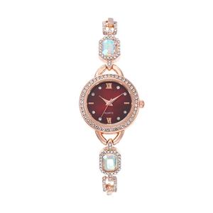 Detail of rose gold quartz watch with wine red dial and sparkling rhinestone bezels